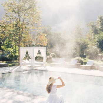 Woman at the pool with a hat | 5 Star Superior Wellnesshotel Alpenpalace, South Tyrol