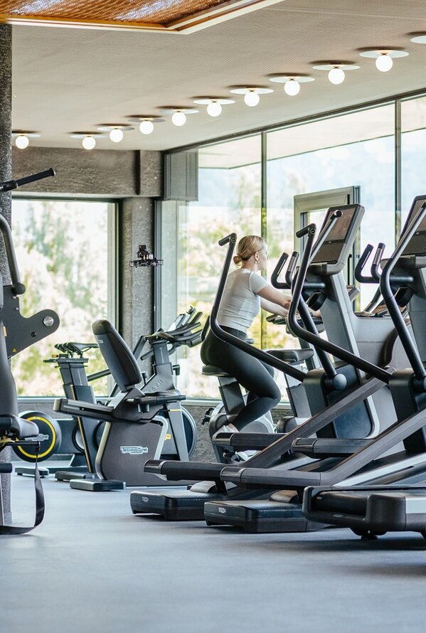 Bright fitness room with modern equipment and large windows