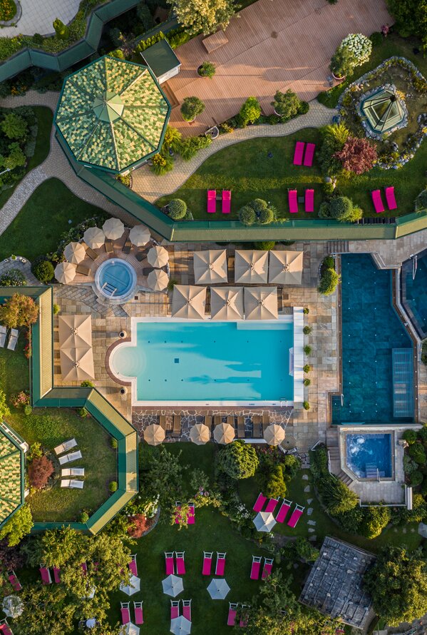 Aerial view of a spacious wellness and garden area with pools and relaxation spaces.