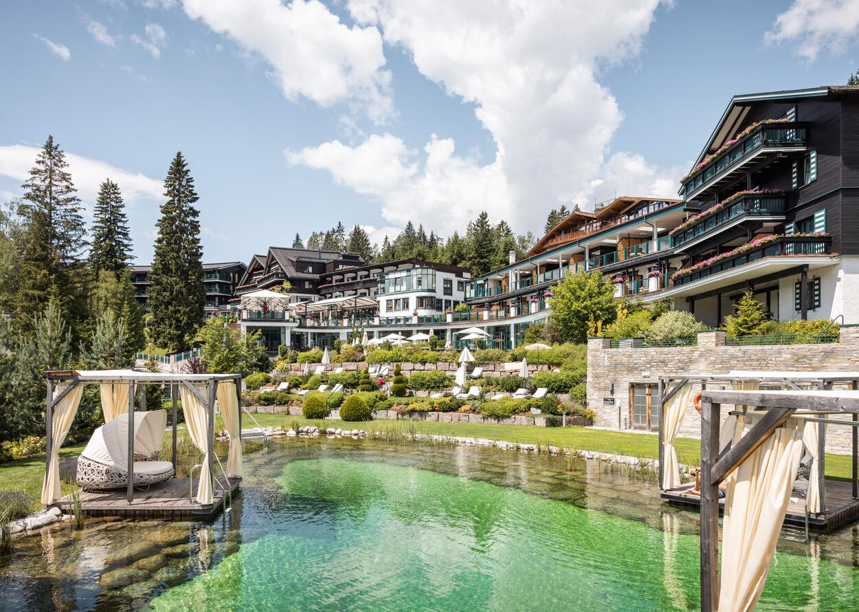 Alpin Resort Sacher Seefeld with pool and green terraces on a sunny day