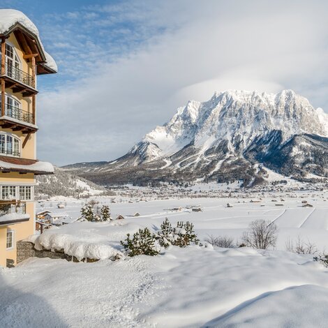 Winter view of the Hotel Post against a snow-covered mountain backdrop