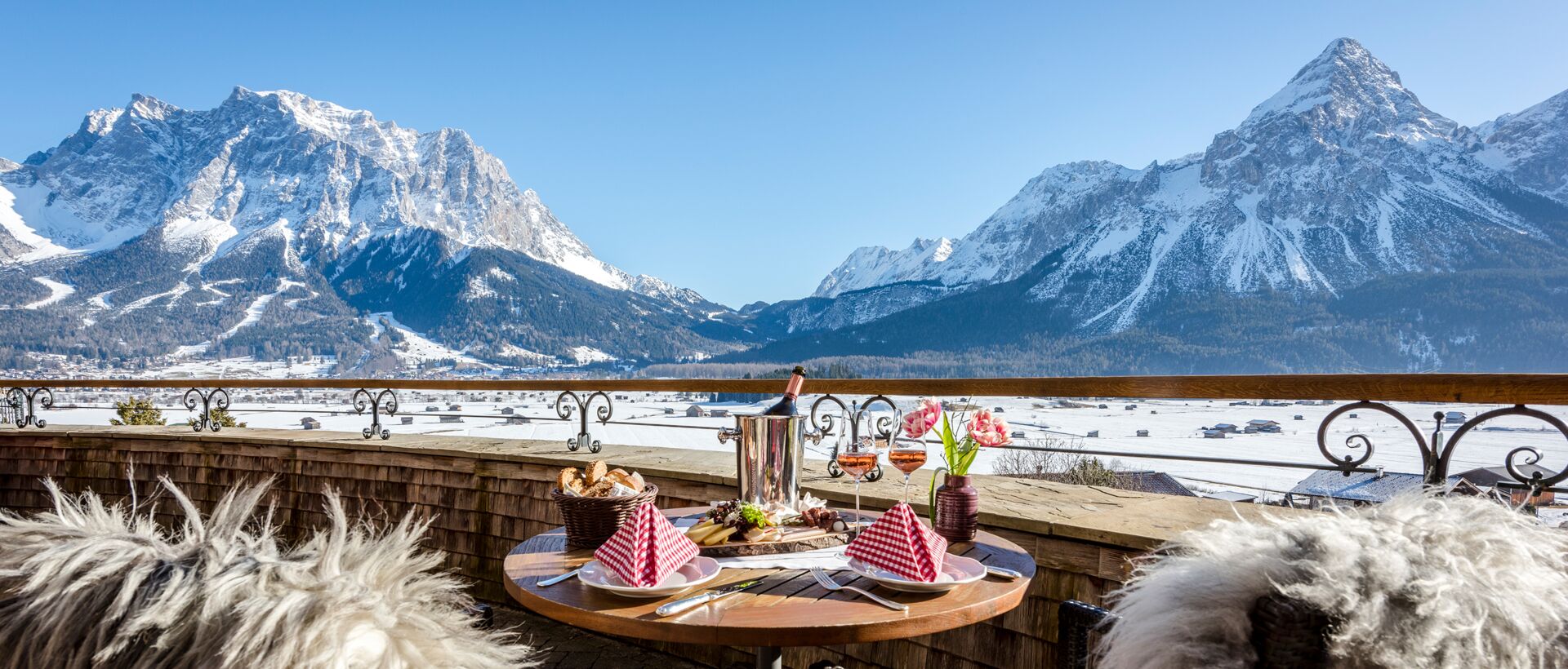 Gedeckter Tisch auf Balkon mit Bergblick im Winter