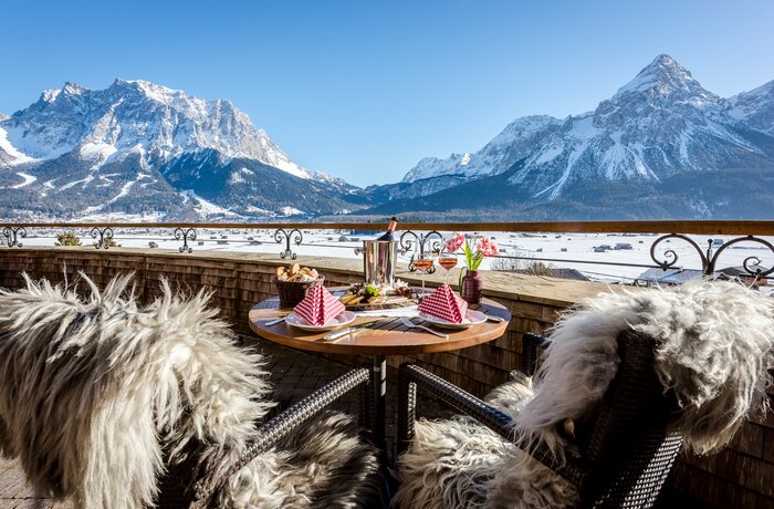 Gedeckter Tisch auf Balkon mit Bergblick im Winter
