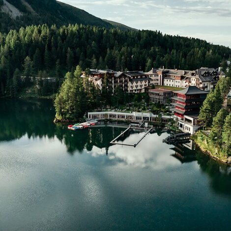 Hotel complex on the lake, surrounded by forest and mountains