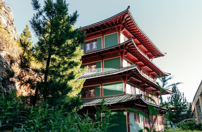 Asian-inspired pagoda building surrounded by lush natural scenery.