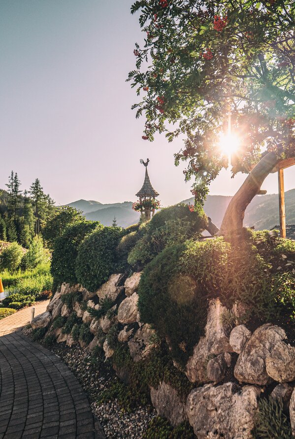 Sunny garden path with alpine natural scenery.