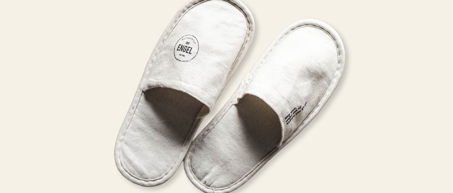 White hotel slippers on a light background.
