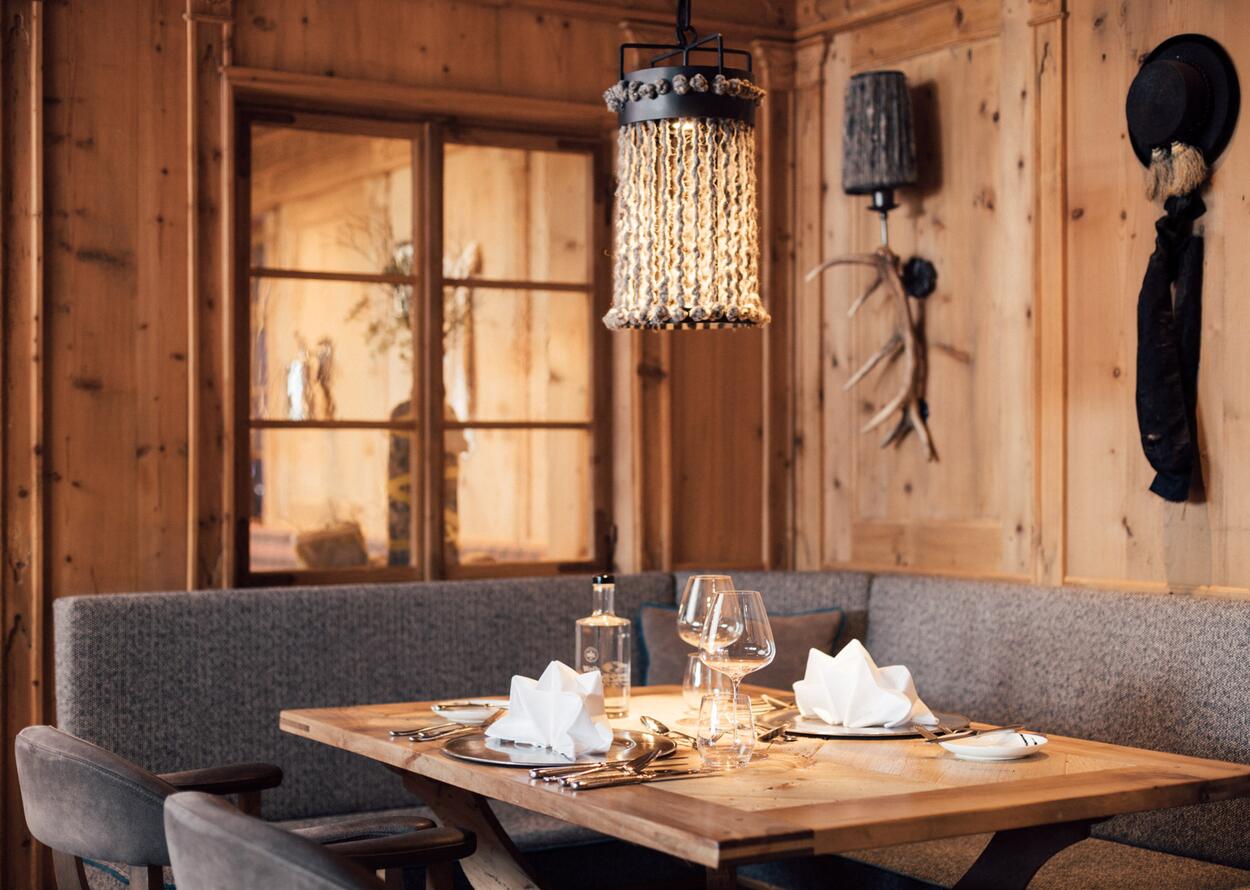Wood-paneled room with table, glasses, lamp and window