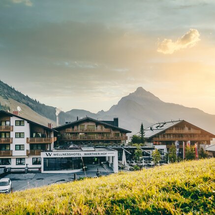 Wellnesshotel Warther Hof vor Bergkulisse im Abendlicht