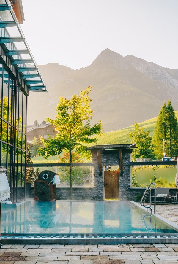 Outdoor pool with crystal-clear water and breathtaking alpine views for pure relaxation.