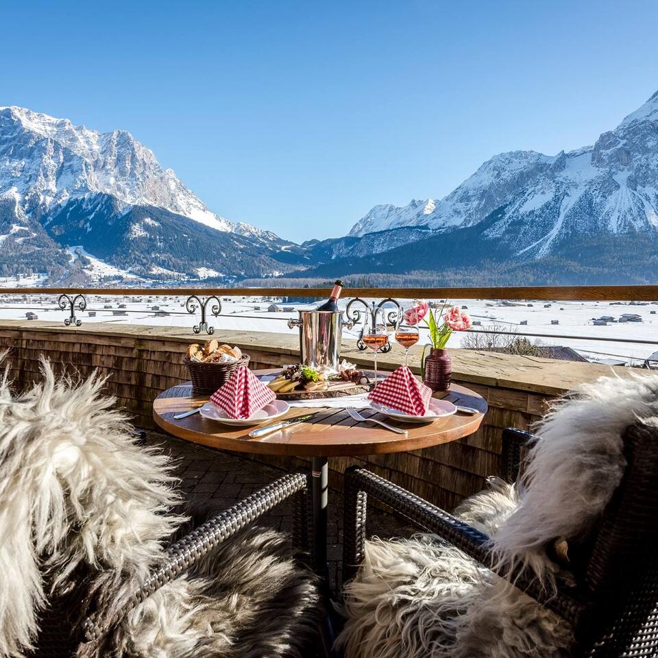 Set table on balcony with mountain view in winter