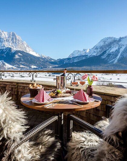 Set table on balcony with mountain view in winter