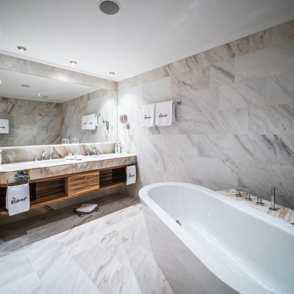 Modern bathroom with marble, bathtub and double sink