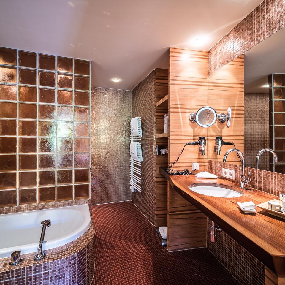 Modernes Badezimmer mit Badewanne, Waschtisch und Spiegel