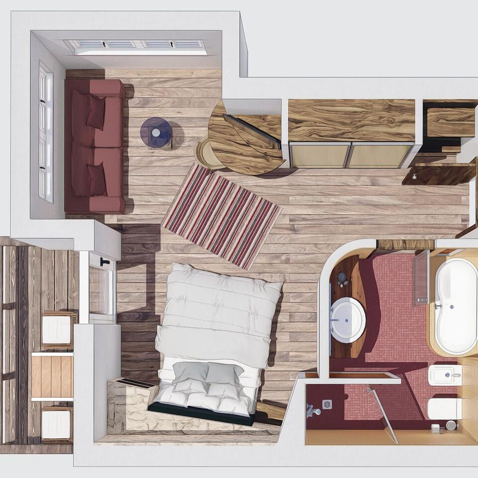 Draufsicht auf einen möblierten Raum mit Bett, Sofa, Tisch und Badezimmer