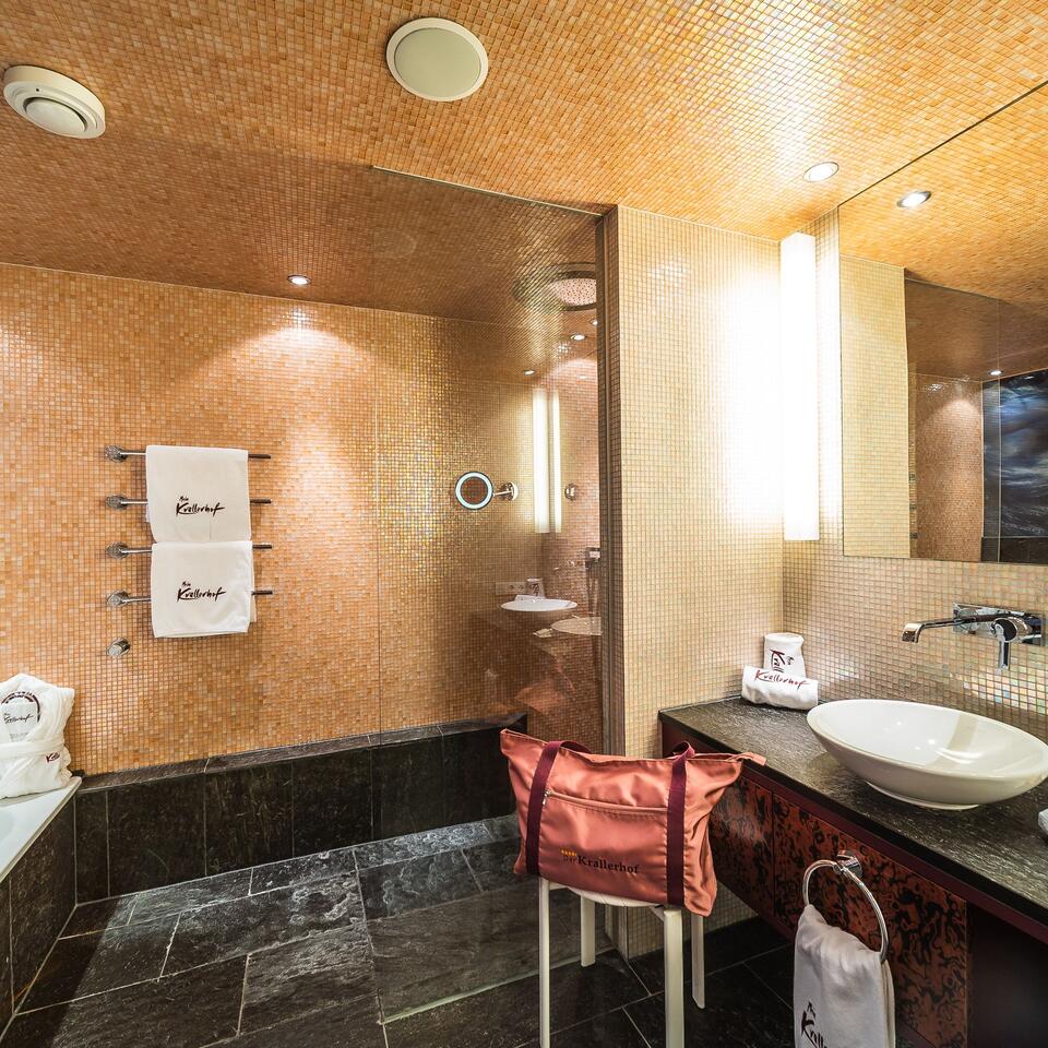 Modern bathroom with shower, sink and towels