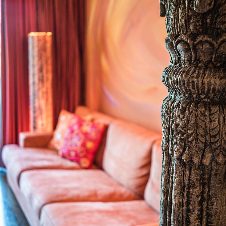 Cozy living room with sofa, floor lamp and carved column