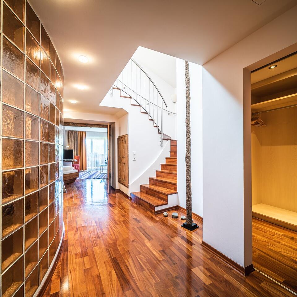 Hallway with wooden floor, glass block wall and stairs